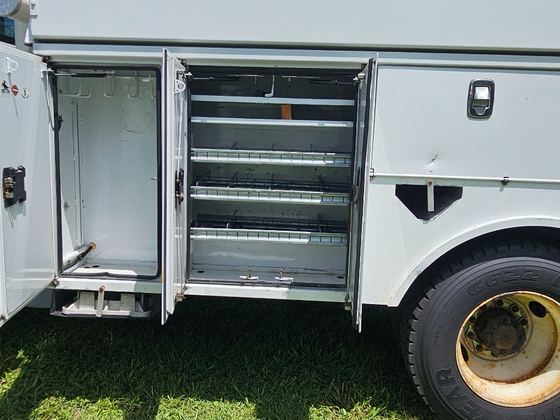 Side utility compartments and boom